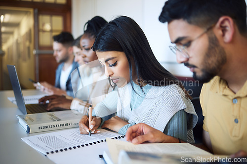Image of University, education and students studying for exam, test or assignment in the library on campus. Scholarship, knowledge and young friends learning in college class with technology and information.