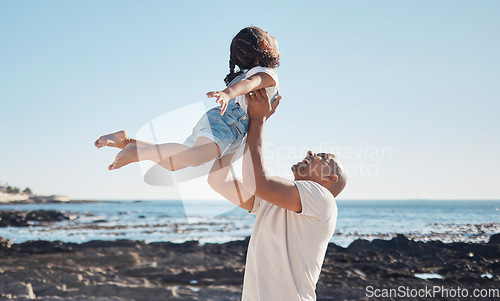 Image of Beach, man holding girl in air and playful for vacation, summer and weekend break. Father swing daughter, relax and bonding at seaside, holiday and loving together for quality time, outdoor and smile