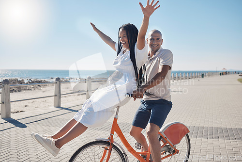 Image of Bicycle, beach and couple with freedom, travel and summer holiday in city sidewalk for wellness, love and care in sunshine. Mental health, black woman and cycling partner at ocean on blue sky mockup