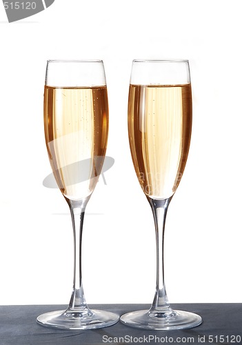 Image of Two elegant champagne glasses on a dark surface