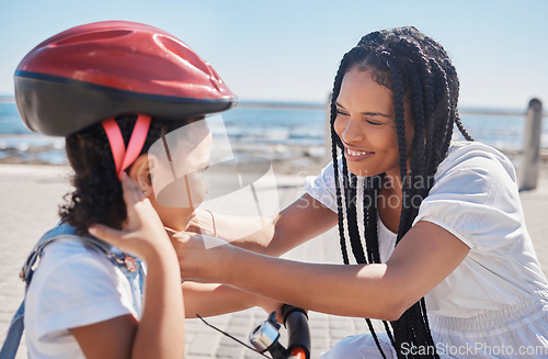 Image of Mother, child or bike helmet help by beach, city ocean or sea in riding safety, learning security or fun activity protection. Happy smile, bonding mom or girl bicycle and Brazilian cycling transport