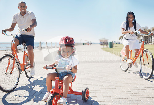 Image of Cycling, bonding and family on the promenade with a bike for summer fitness, fun and quality time in Thailand. Learning, happiness and girl child with bicycle, mother and father at a park by the sea