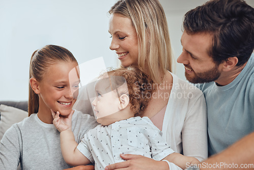 Image of Family, baby and girl with father and mother in living room, having fun and bonding. Love, support and happy man, woman and kid with infant smiling, caring and enjoying quality time together in home.