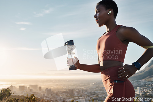 Image of Black woman, water bottle or earphones in running workout goals, healthcare wellness training or sunset city exercise. Fitness drink, sports athlete or runner listening to motivation radio at sunrise