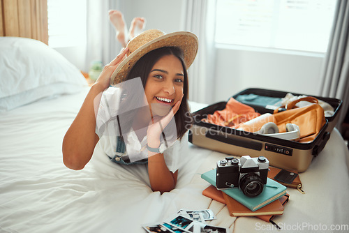 Image of Travel, luggage and woman on bed with clothes, camera and suitcase for adventure, holiday and vacation. Traveling lifestyle, freedom and portrait of girl in bedroom pack for journey, tourism and trip