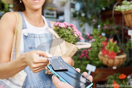 Image of Customer, shopping and credit card for florist shop payment with POS machine or phone for sale of flowers at small business. Hands of woman paying with rfid technology for service at retail store