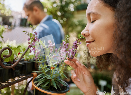 Image of Smelling, plants and face of a woman at a nursery, flower shopping and aroma at a garden market. Happy, peace and girl with smell of flowers, pot plant and floral heather ecology at a gardening shop