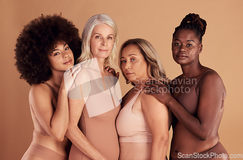 Image of Beauty, diversity and group of women in lingerie in studio on a brown background. Underwear, makeup or cosmetics of body positive friends or female models posing for feminine empowerment or self love