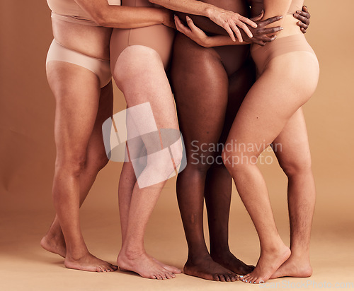 Image of Diversity, legs and body positivity, women in underwear huddle together on studio background. Feet, friends and health, empowerment in self love and care in global community of diverse female bodies.