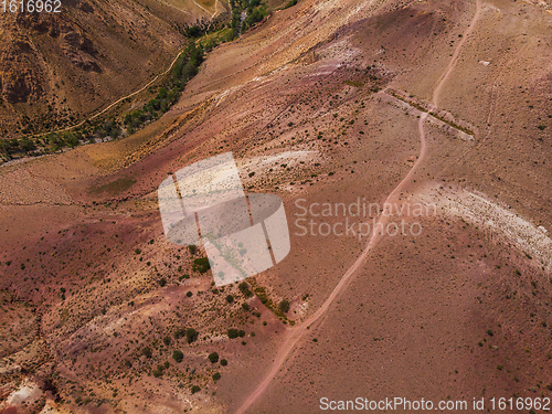 Image of Aerial shot of the textured yellow nad red mountains resembling the surface of Mars