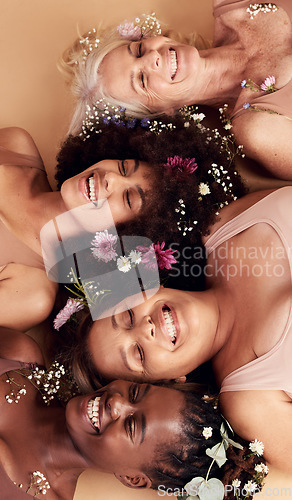 Image of Top view, women diversity or faces with flowers on studio background in empowerment, divine feminine energy or self love. Smile, happy or skincare beauty models with plants, leaf or organic spa glow