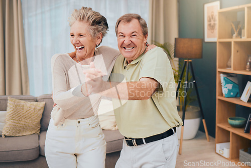 Image of Happy, dance and senior couple in a living room, smile and fun while being silly in their home together. Happy family, love and man with woman dancing, laughing and goofy while enjoying retirement