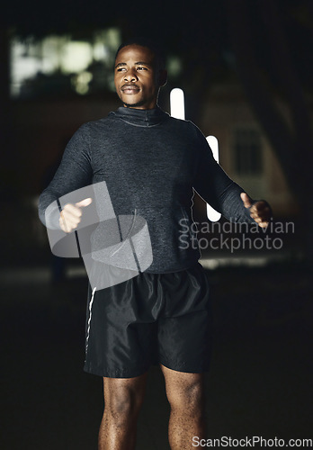 Image of Fitness, night or black man ready for running exercise, cardio training or late workout in a dark city in Nigeria. Start, mindset or healthy athlete runner thinking of sports goals, mission or vision