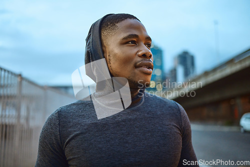 Image of Runner, fitness and exercise with a sports black man in the city for a cardio or endurance workout. Wellness, motivation and thinking with a young male athlete in an urban town for marathon training