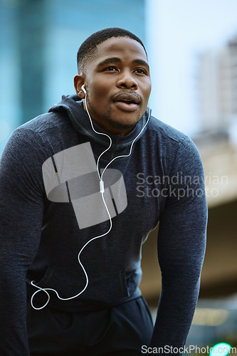 Image of Breathe, black man and fitness break for city workout, wellness exercise and running outdoors. Runner, breathing and relax after cardio marathon with music earphones for motivation, mindset and goals