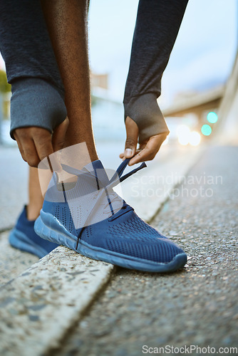 Image of Workout, fitness and man tying shoes on feet on city street before marathon training or running. Health, wellness and sports footwear, motivation for exercise for black man athlete or urban runner.