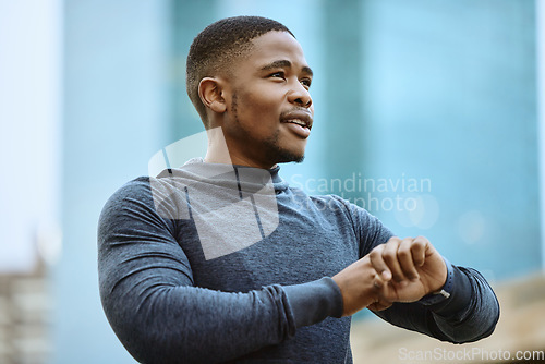 Image of Running, fitness and watch with a sports black man checking his time while outdoor for a cardio run. City, thinking and goal with a male runner or athlete in a town for exercise or a workout