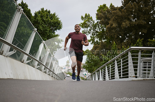 Image of Black man running on bridge in city for fitness, exercise and healthy goals, sports wellness and marathon workout. Urban runner, cardio and training to lose weight with power, action and motivation