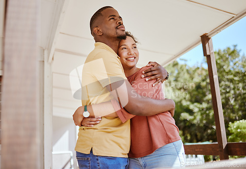 Image of Black couple, bonding and love hug in house or home patio as new property owners, mortgage investment success or real estate buyers. Smile, happy and embrace man and woman with future security goals