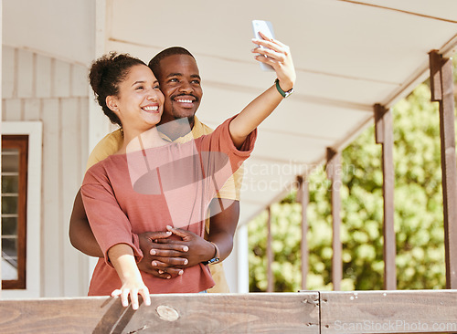 Image of Love, phone selfie and black couple in home by balcony, bonding and having fun. Romance, hug and man and woman taking pictures on mobile smartphone for happy memory, social media or profile picture.