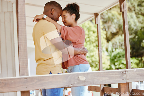 Image of Hug, love and black couple with care, peace and praying on the porch of their house together in New Zealand. Trust, relax and African man and woman with gratitude, affection and calm at their home