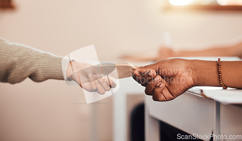 Image of Hands, students pass note in classroom, communication and secret at school with message on paper. Education, learning and people in class for lesson, scholarship and academic with letter writing.