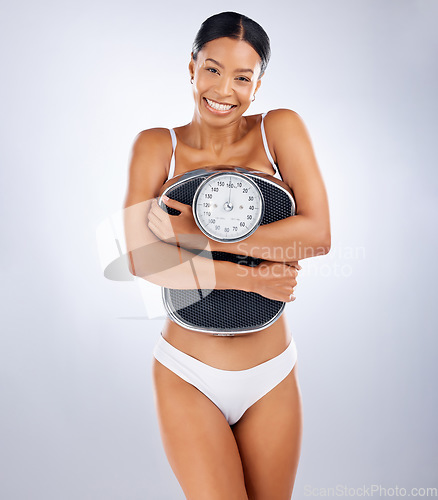 Image of Woman, scale and weight loss portrait with underwear, health and wellness with smile by studio background. Black woman, diet and body goals for fitness, happiness and self care in by studio backdrop