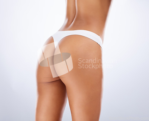 Image of Cellulite, skincare and butt of a woman in underwear for dermatology spa, beauty and wellness of body on a grey studio background. Cosmetology, sexy and buttocks of a slim model in lingerie