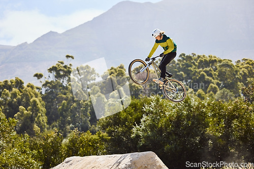 Image of Mountain biking, sports and man training in nature, cycling energy and in air for a competition in Turkey. Exercise, danger and athlete with a mountain bike for fitness, speed and jump during contest