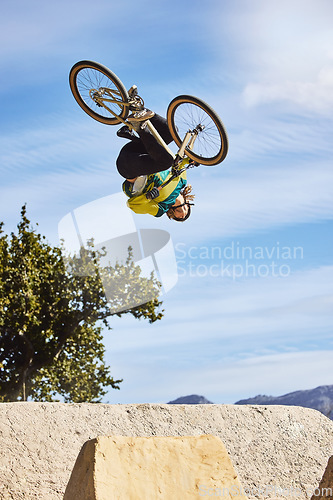 Image of Cycling sports, bike and jump of man performing stunt outdoors in nature. Trick, dangerous risk and biker, rider or bmx athlete on bicycle jumping on ramp for training exercise, workout and fitness