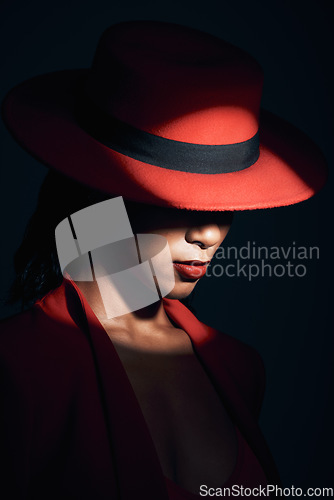 Image of Fashion, red suit and woman in the dark for vintage clothes, retro and mafia aesthetic on a black studio background. Designer, mysterious and face of an elegant model with classy and fancy style