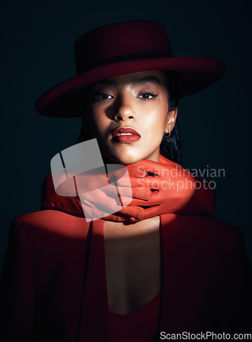 Image of Beauty, makeup and fashion of a black woman in dark studio with spotlight on face for cosmetics, designer brand clothes and art deco. Portrait of London model with red lipstick and hand glove on neck