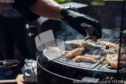 Image of A professional cook prepares shrimps