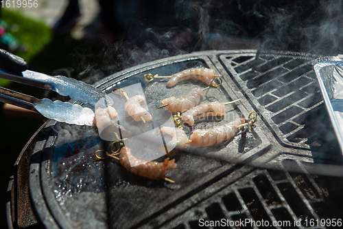 Image of A professional cook prepares shrimps