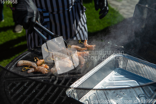 Image of A professional cook prepares shrimps