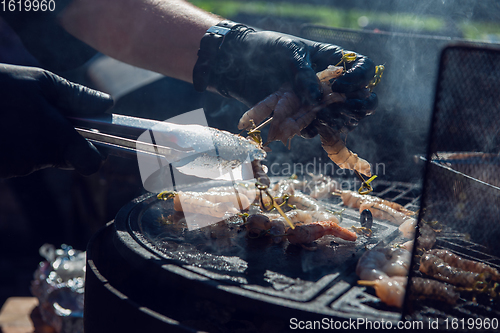Image of A professional cook prepares shrimps