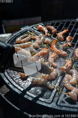 Image of A professional cook prepares shrimps