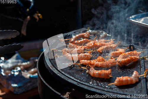 Image of A professional cook prepares shrimps