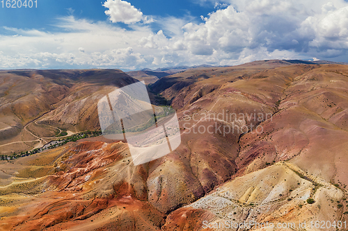 Image of Aerial shot of the textured yellow nad red mountains resembling the surface of Mars