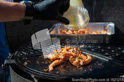 Image of A professional cook prepares shrimps