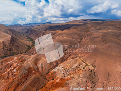 Image of Aerial shot of the textured yellow nad red mountains resembling the surface of Mars