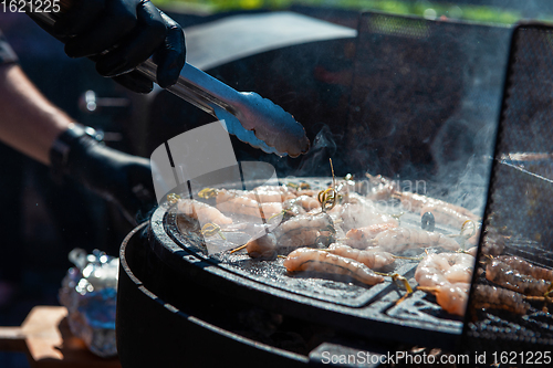 Image of A professional cook prepares shrimps