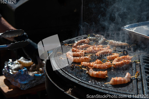 Image of A professional cook prepares shrimps