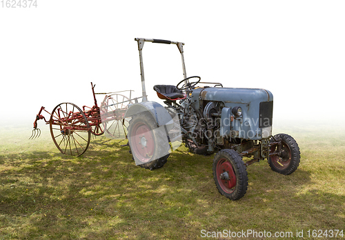 Image of historic tractor with agricultural device