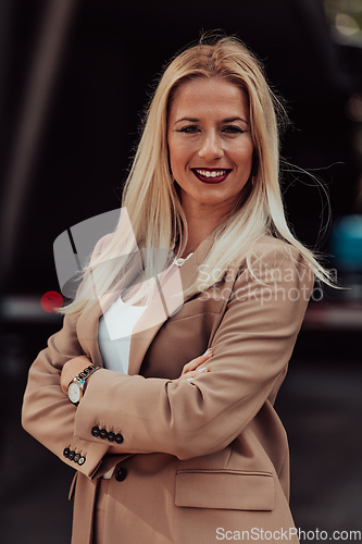 Image of A powerful portrait of a businesswoman, standing confidently with her arms crossed, representing the determination of the female gender and embodying strength and success