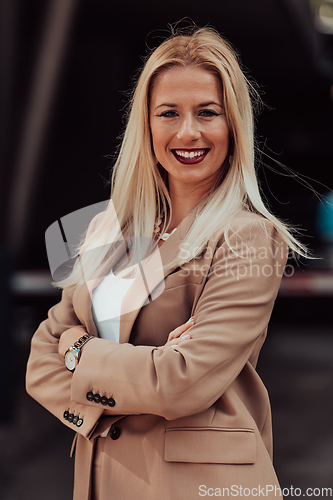 Image of A powerful portrait of a businesswoman, standing confidently with her arms crossed, representing the determination of the female gender and embodying strength and success