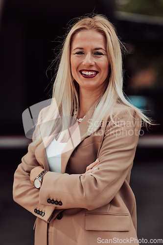 Image of A powerful portrait of a businesswoman, standing confidently with her arms crossed, representing the determination of the female gender and embodying strength and success