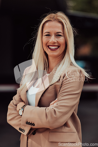 Image of A powerful portrait of a businesswoman, standing confidently with her arms crossed, representing the determination of the female gender and embodying strength and success