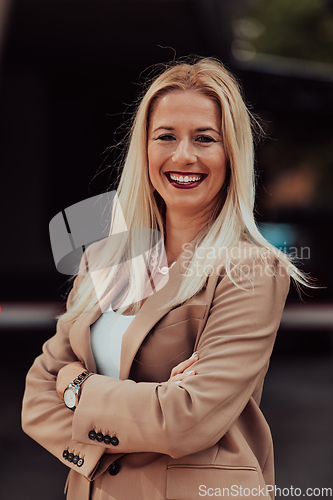 Image of A powerful portrait of a businesswoman, standing confidently with her arms crossed, representing the determination of the female gender and embodying strength and success