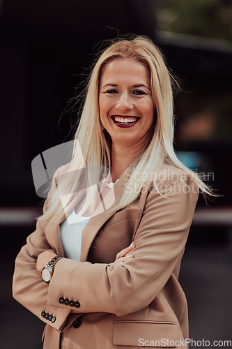 Image of A powerful portrait of a businesswoman, standing confidently with her arms crossed, representing the determination of the female gender and embodying strength and success